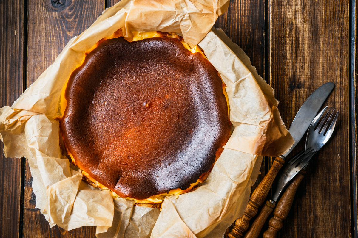 Top view of delicious basque burnt cheesecake on rustic table